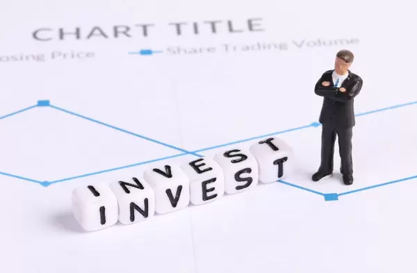 Businessman figure with Invest text