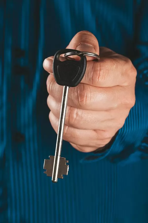 Businessman holding a key, close up