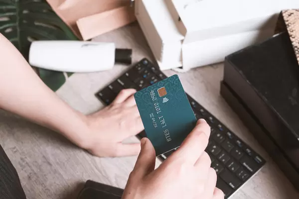 Businessman holding credit card and typing on laptop for online shopping and payment makes a purchase on the Internet