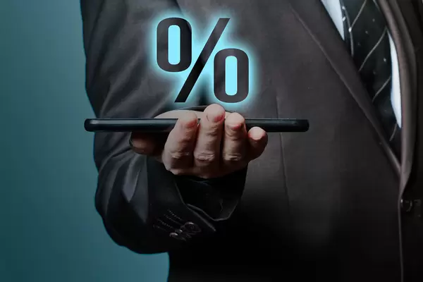 Businessman holding tablet with percent icon