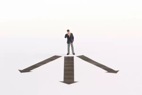 Businessman in front of decision which way to choose