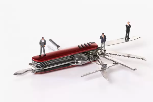 Businessman people standing on Swiss army knife