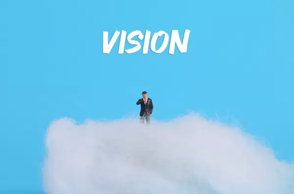 Businessman standing on cloud