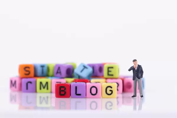 Businessman with colorful toy blocks with Blog text