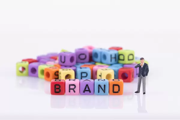 Businessman with colorful toy blocks with Brand text