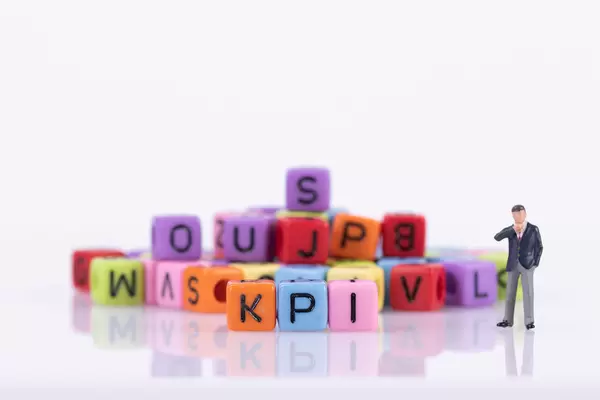 Businessman with colorful toy blocks with KPI text