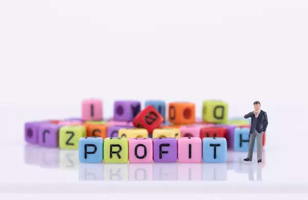 Businessman with colorful toy blocks with Profit text