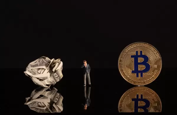 Businessman with crumpled money and golden Bitcoin