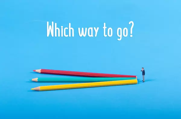 Businessman with three colorful pencils and Which way to go text
