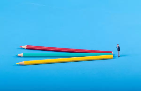 Businessman with three colorful pencils