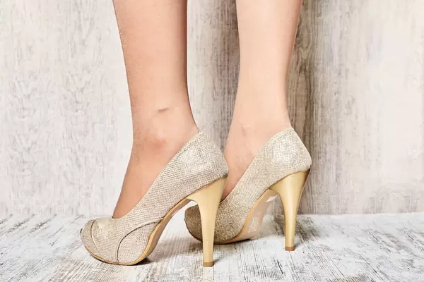 Businesswoman putting on a pair of heels