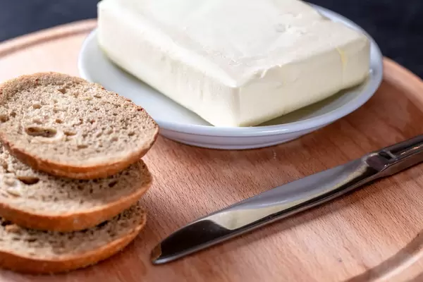 Butter a slice of rye bread on kitchen Board