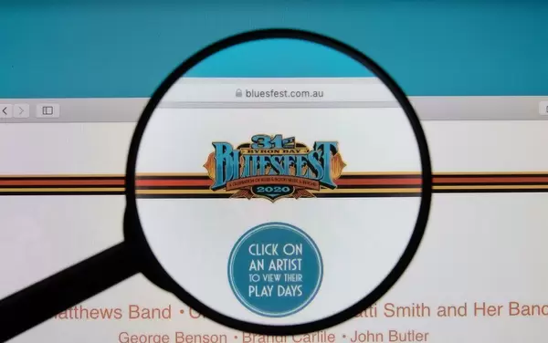 Byron Bay Bluesfest logo on a computer screen with a magnifying glass