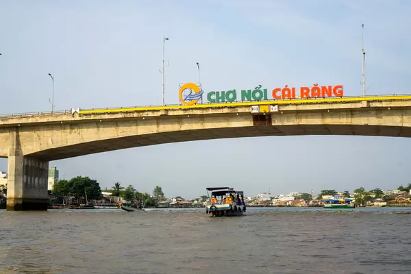 Cai Rang Floating Market Sign on a Bridge over the Mekong River with Tourist Boats in Can Tho, Vietnam