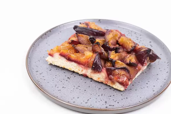 Cake Pie with fresh Plums served on the plate