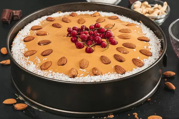 Cake with condensed milk, coconut, nuts and red currant berries