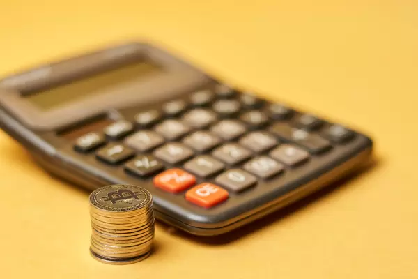 Calculator and stack of bitcoins