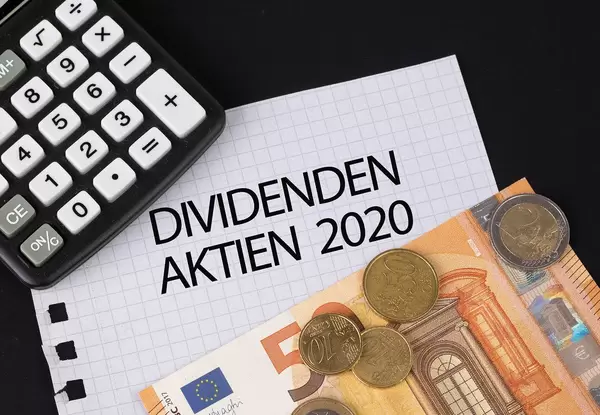Calculator, money and Dividenden Aktien 2020 text on black table