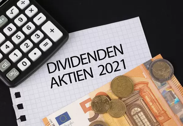 Calculator, money and Dividenden Aktien 2021 text on black table