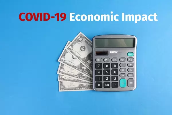Calculator with money and COVID-19 Economic Impact text