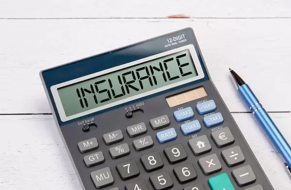 Calculator with the word Insurance on the display