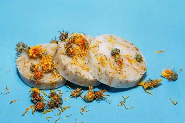 Calendula handmade soap isolated on blue background