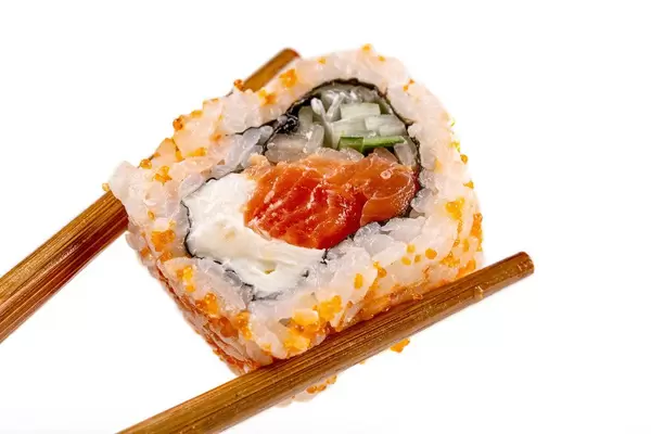 California roll with salmon and chopsticks, close-up