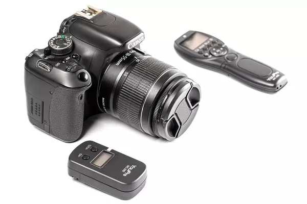 Camera and remote control on white background