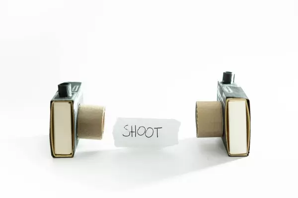 Cameras looking at each other with lable reading SHOOT