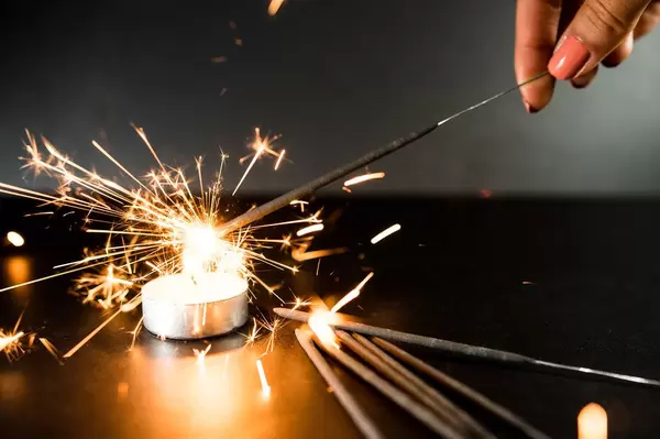 Candle lighting a christmas sparkler
