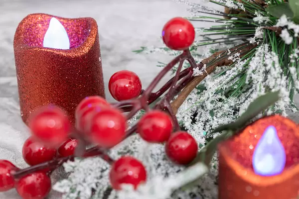 Candles and winter Christmass decoration with frozen branches