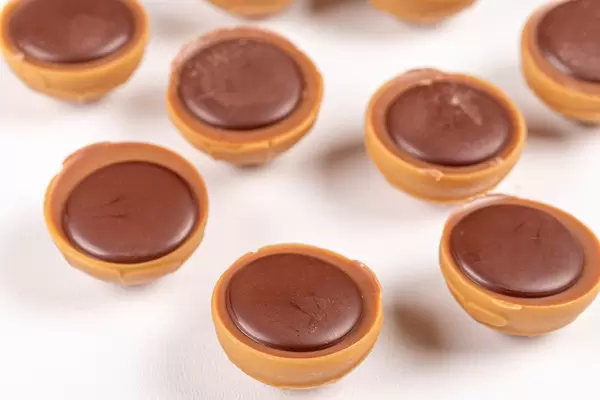 Candy with caramel, chocolate and nuts on a white background (Flip 2020)
