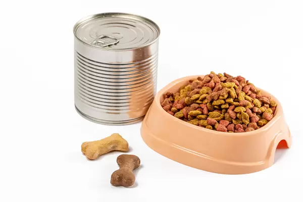 Canned food with pet food with dry food on white background