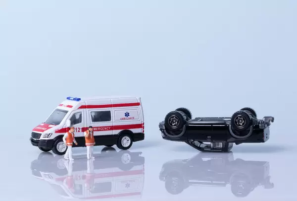 Car crash concept with ambulance and medical workers