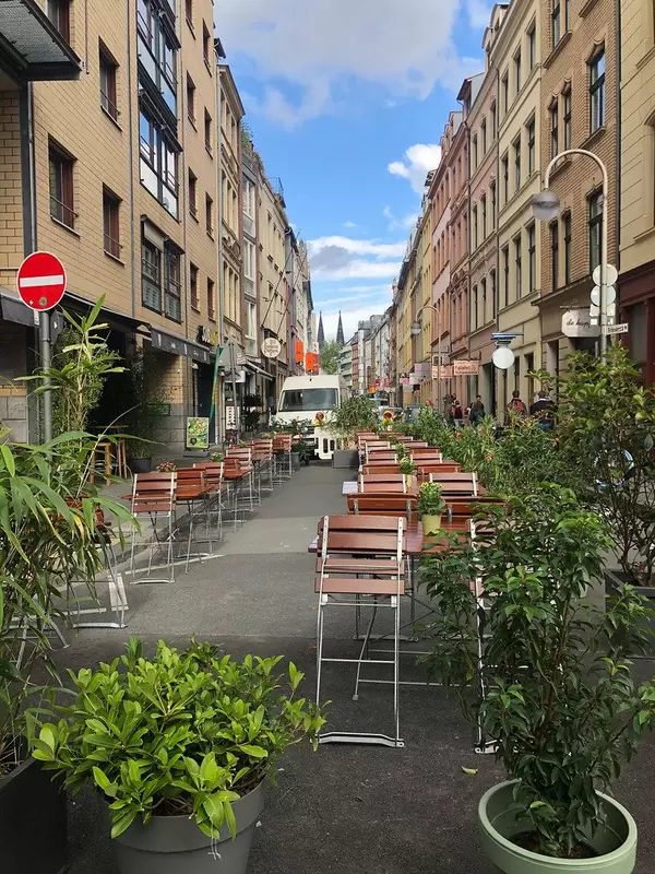 Car-free-street in Cologne, Germany: New pedestrian zone Friesenstrasse with green plants  in the middle of a big City