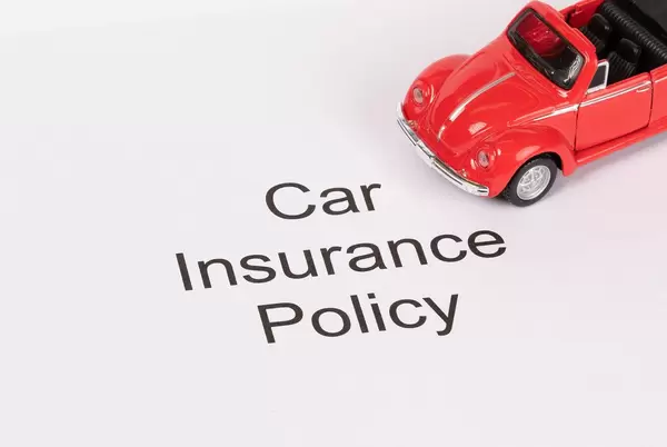 Car Insurance Policy with red toy car