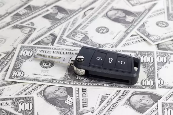 Car keys on hundred dollar banknotes