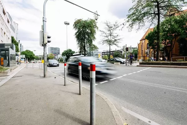 Car moving fast at an intersection in an urban environment
