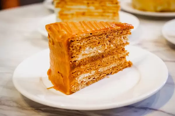 Caramel cake slice on marble table top