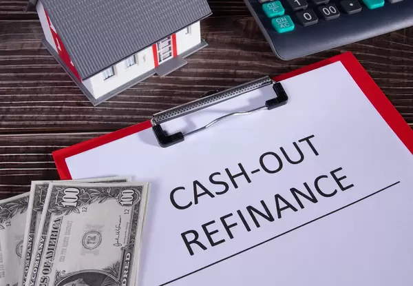 Cash out refinance documents, calculator, money and small family house
