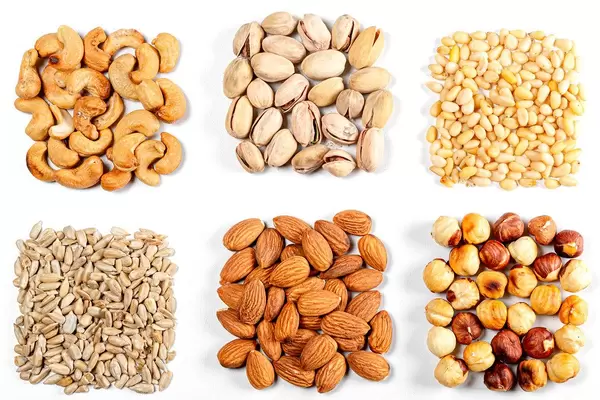 Cashew-nuts-pistachios-pine-nuts-almonds-hazelnuts-and-sunflower-seeds-on-a-white-background.jpg