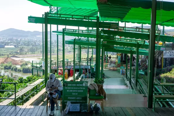 Cashier and Entrance to the Terrace in the Private Area of Me Linh Coffee Garden in Dalat, Vietnam