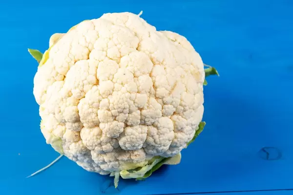 Cauliflower on the blye wooden board (Flip 2019)