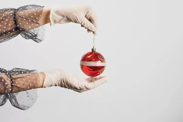 Celebrating christmas in quarantine. Woman holding xmas toy