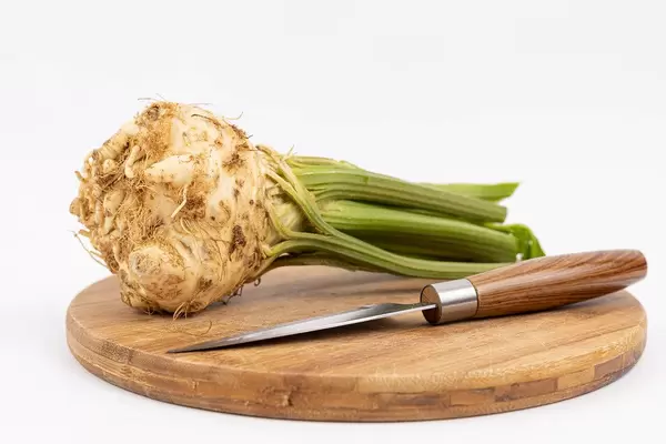 Celery Root on the wooden board with knife