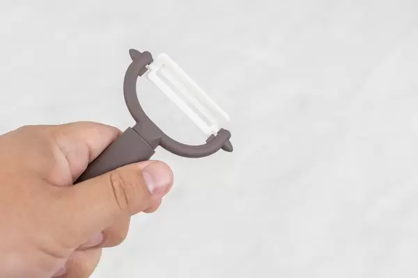 Ceramic Peeling knife for vegetables in the hand with copy space