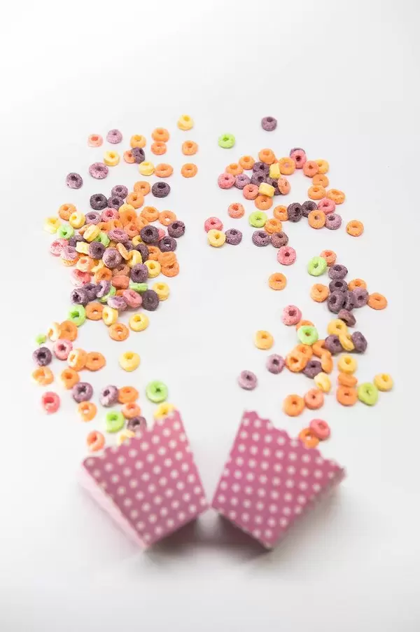 Cereal coming out of pink cardboard cups