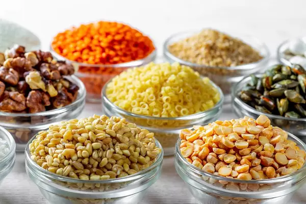 Cereals, seeds and nuts in glass bowls close-up