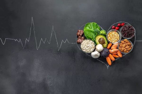 Chalked heart and pulse on a black background with useful products. Top view (Flip 2019)