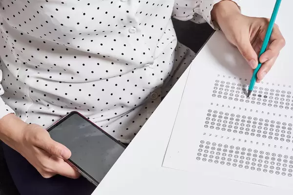 Cheating on exam. A student using phone during examination